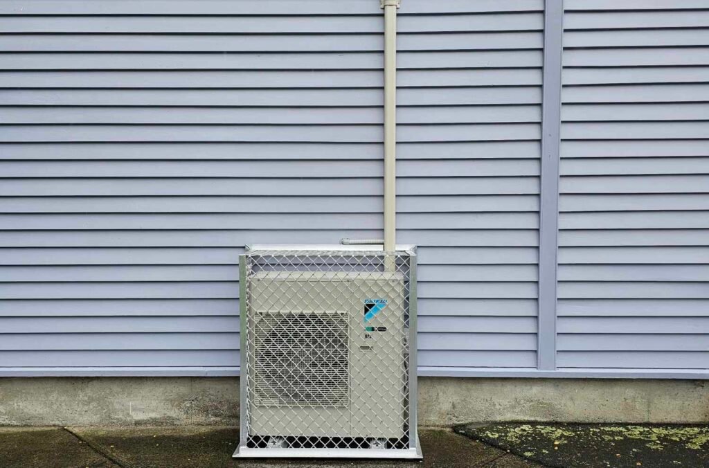 Daikin outdoor heat pump unit in cage