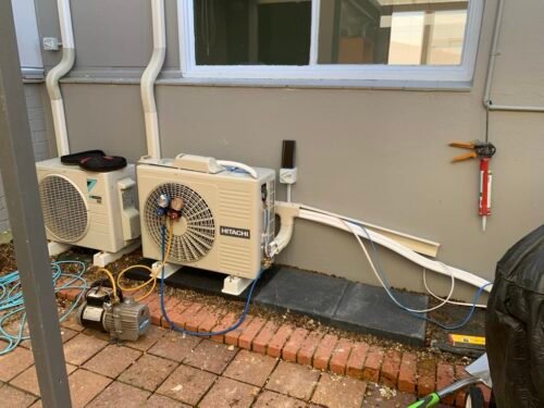 Commercial heat pump outdoor unit installation image. Checking levels of refrigerant